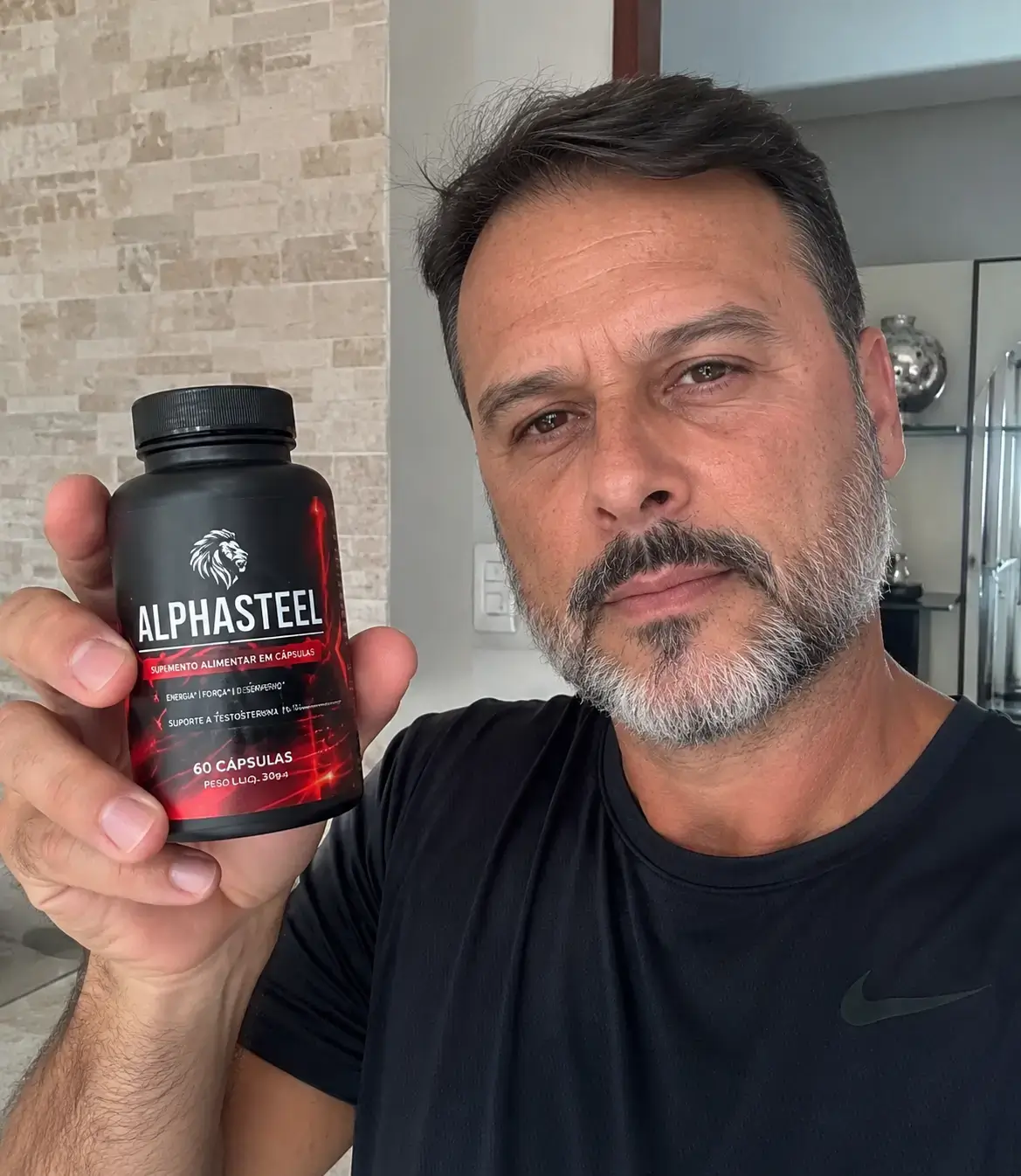 Man holding a bottle of AlphaSteel